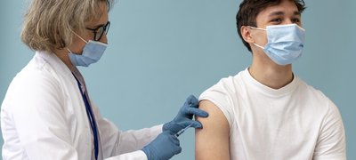 medium-shot-man-getting-vaccine.jpg